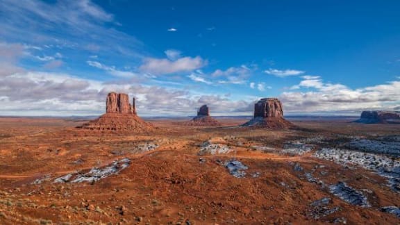 a view of a desert with rock formations
