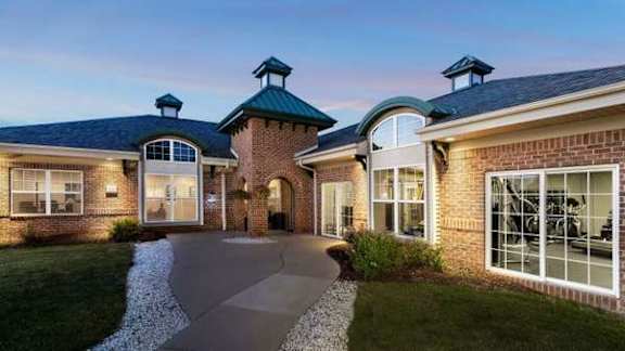 A modern house with a brick facade and a curved driveway.