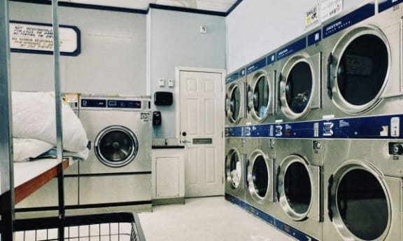 a row of washing machines in a laundromat