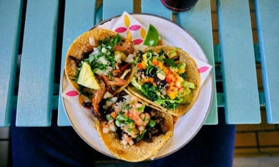 two tacos on a plate on a table