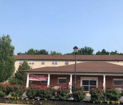 a brick building with flowers in front of it