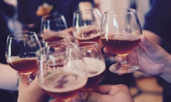 a group of people holding wine glasses