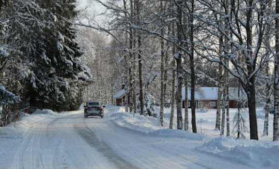 a car driving down a snow covered road