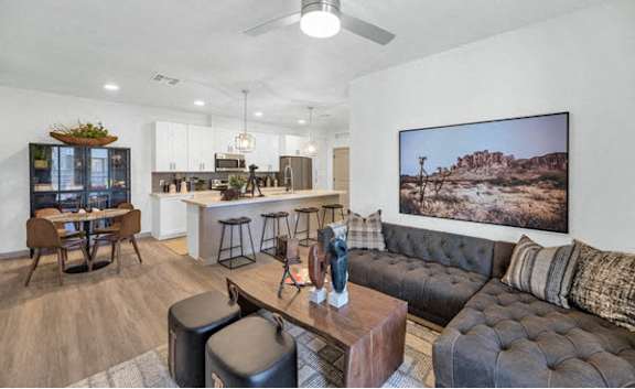 a living room with a black couch and a television