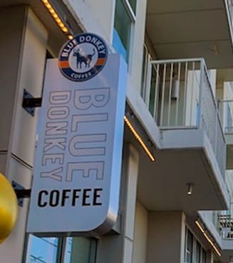 a sign for a coffee shop on the side of a building at Link Apartments® Canvas, Atlanta, GA, 30312