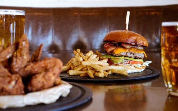 a sandwich and fries and a glass of beer