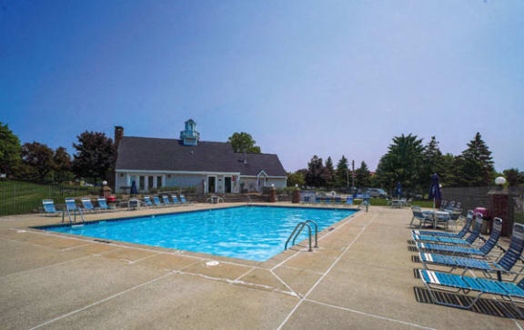 Shimmering Swimming Pool with Wrap-Around Sundeck at Apple Ridge Apartments in Walker, Michigan