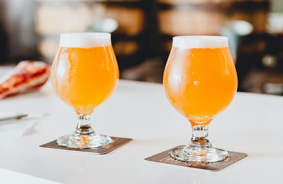 two glasses of beer on a table