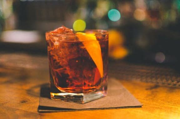 a cocktail sitting on top of a wooden table