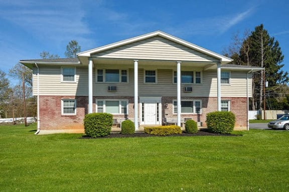 a large house with a lawn in front of it