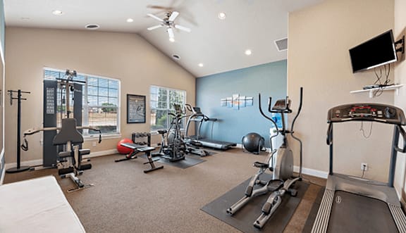 A spacious home gym with a variety of exercise equipment.