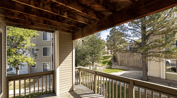 the view from the deck of a home with a wooden porch