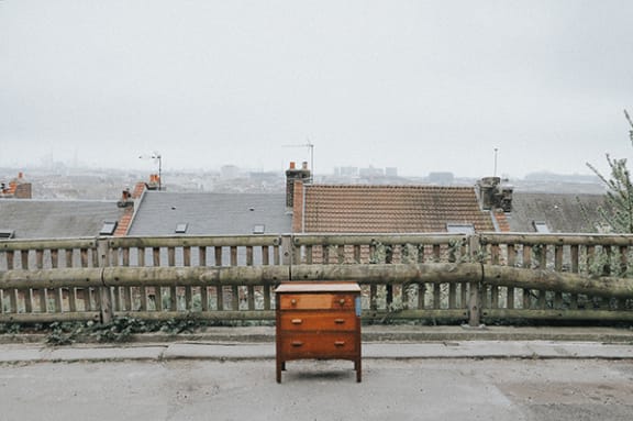 a chest of drawers sitting on the side of the road