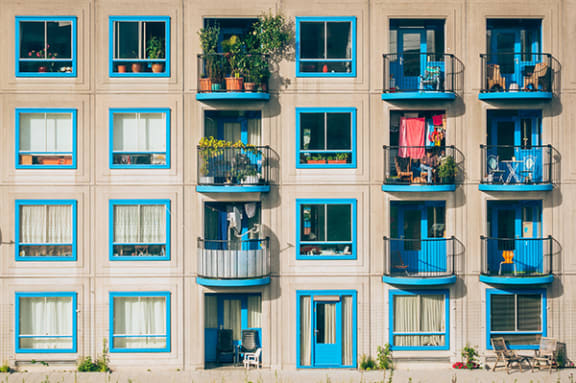 a building with blue windows and balconies