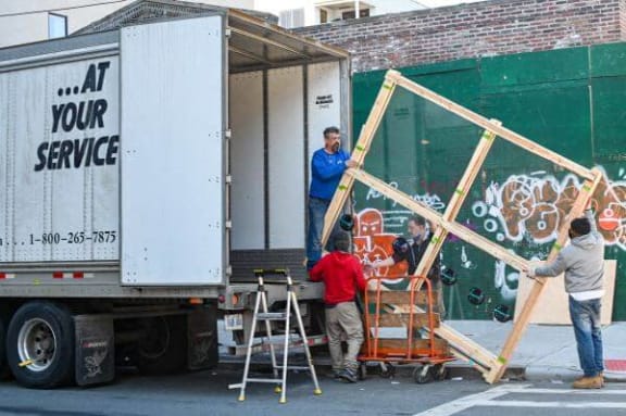 a group of people working on the back of a truck