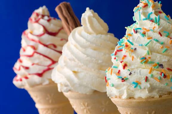 Three ice cream cones with different toppings.