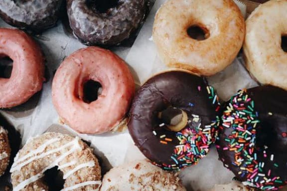 a box of different types of donuts on a paper