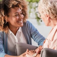 a woman talking to an older woman in a conversation
