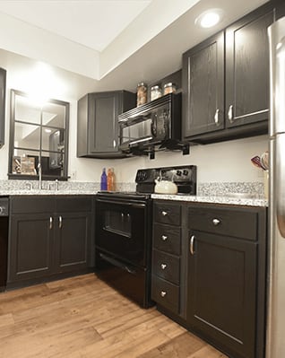 a kitchen with granite counters and stainless steel appliances