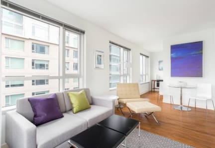 a living room filled with furniture and a large window