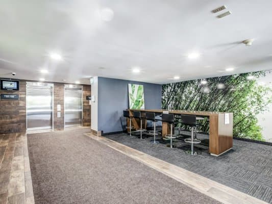 a room with a table and chairs in front of a wall with a mural on it
