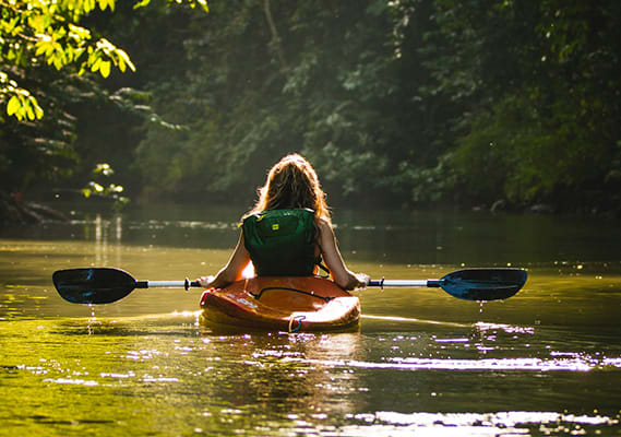 two people are in kayaks on the water