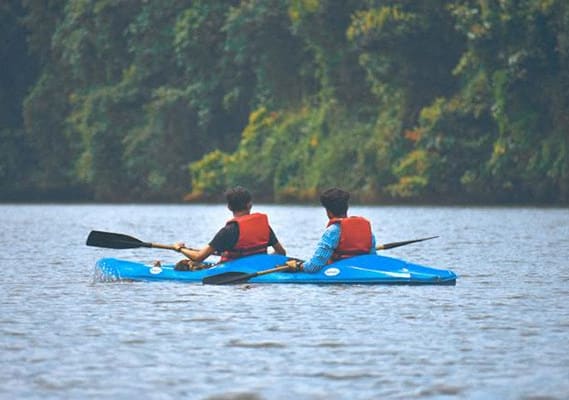 two people in a kayak on a lake