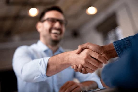 two men shaking hands at a business meeting