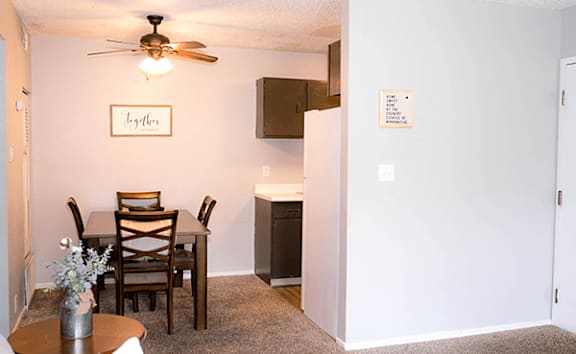 A dining room with a table and chairs.