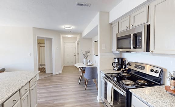 our apartments offer a kitchen with stainless steel appliances and white cabinets