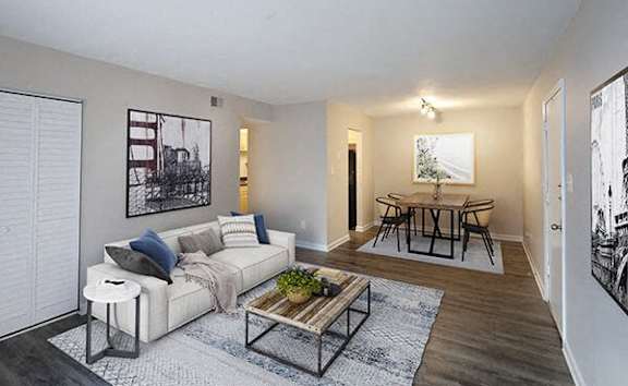 A living room with a white couch and a coffee table.