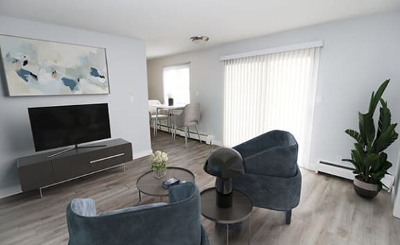a living room filled with furniture and a flat screen tv