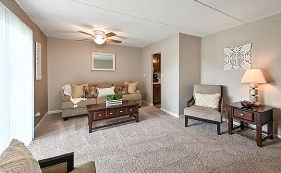 a living room with furniture and a ceiling fan