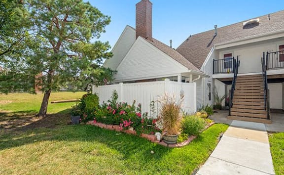 a yard with a white fence and a house