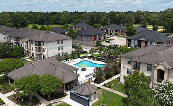 A bird's eye view of a residential area with houses and a swimming pool.