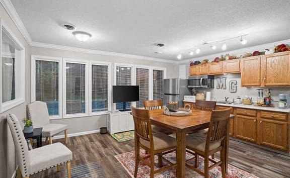 a kitchen and dining room with a table and chairs