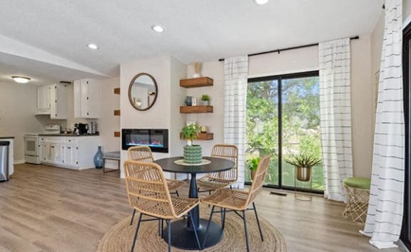 a living room with a table and chairs and a fireplace