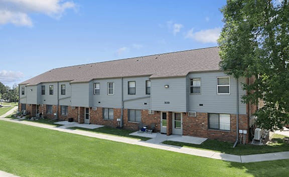 Apartment building with a green lawn in front.