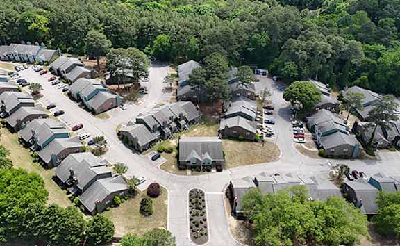 A bird's eye view of a residential area with houses and trees.