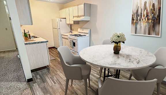 A kitchen with a table and chairs in the foreground and a painting on the wall.