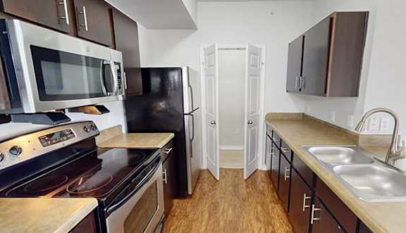 a living room with a dining room table and a kitchen