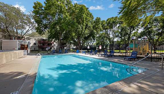 beautiful sunlit swimming pool with shaded area