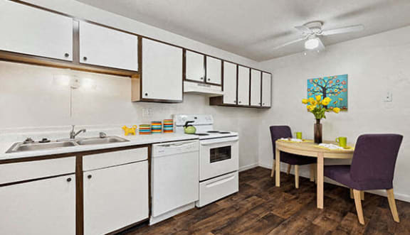 a kitchen and dining room with white cabinets and a table