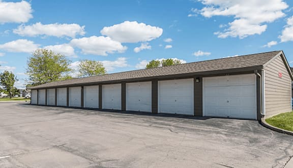 A long building with white garage doors.