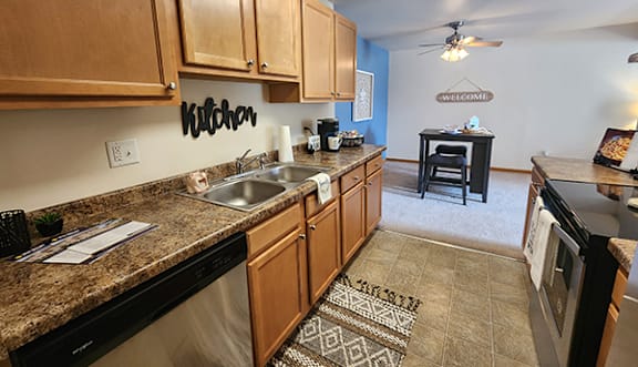 A kitchen with wooden cabinets and a granite countertop.