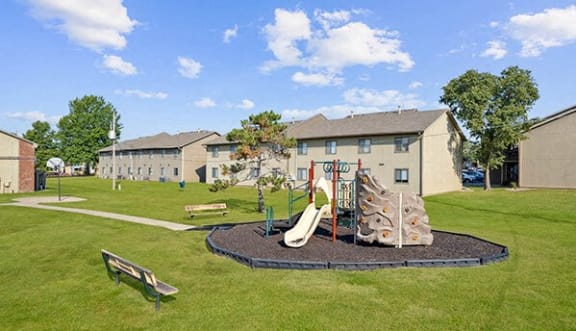 a playground in a park in front of a building