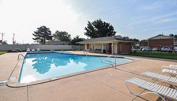 a swimming pool with chairs around it