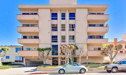 A modern building with a car parked in front.