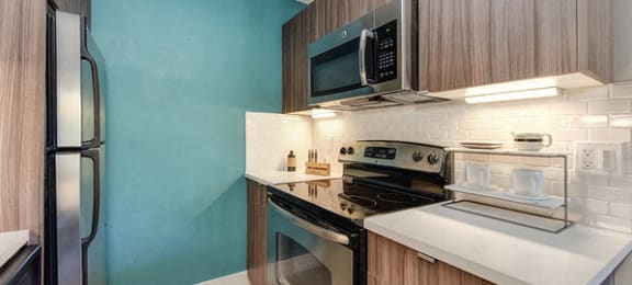 Apartments in Sunnyvale for Rent - Kitchen with Stainless Steel Appliances, Wood Flooring, and Tiled Backsplash