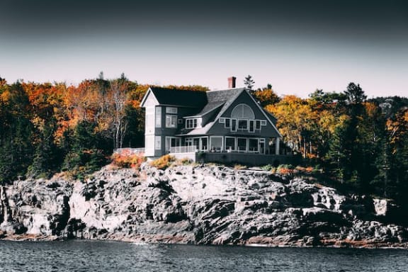 Floor Plan  a house on a rocky island next to a body of water